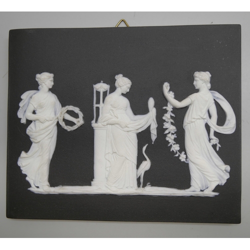 665 - Four Wedgwood black and white Jasper plaques, three rectangular, one oval