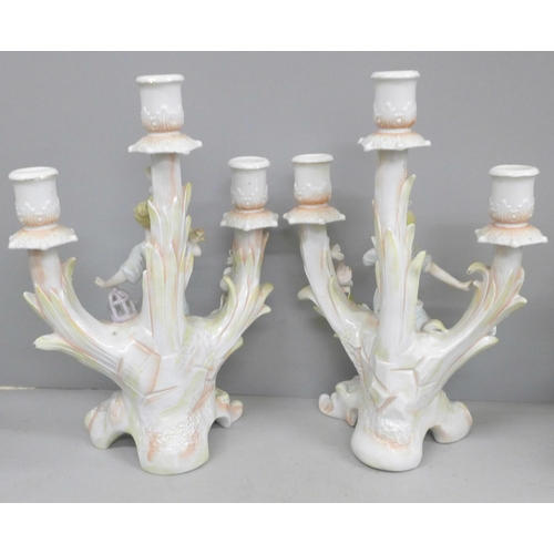 694 - A pair of continental figural candelabra and a pair of glass vases with gilt detail, some petals a/f