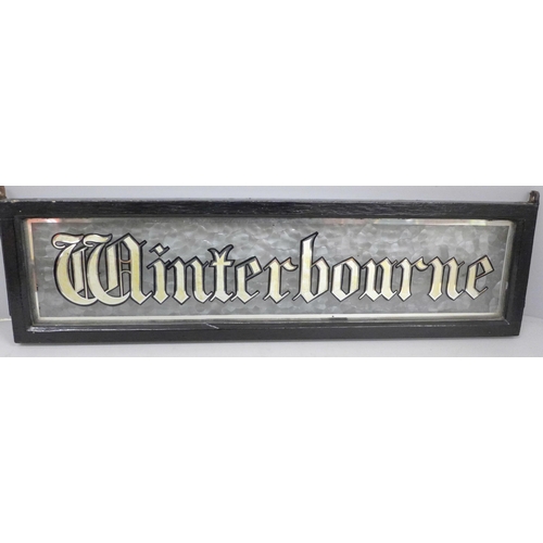 695 - A glass cast metal set sign, ‘Winterbourne’, 51cm