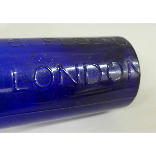 703 - A blue glass ink bottle, marked Hyde 61 Fleets London, 14.5cm