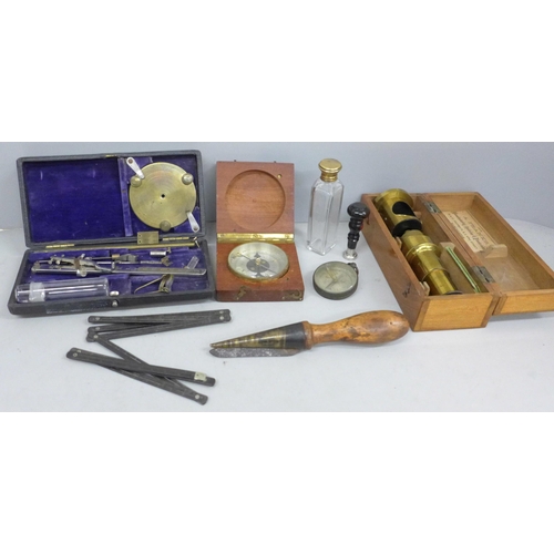 706 - A collection of instruments/tools; a brass microscope, boxed, a leather working tool, two compasses,... 