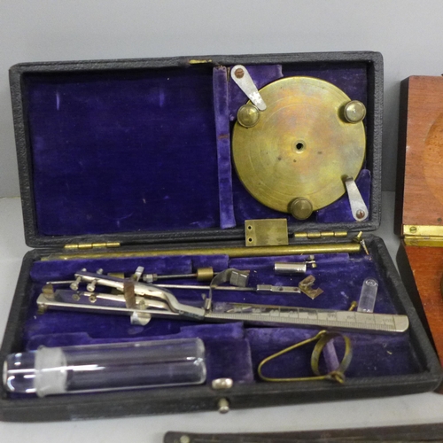 706 - A collection of instruments/tools; a brass microscope, boxed, a leather working tool, two compasses,... 