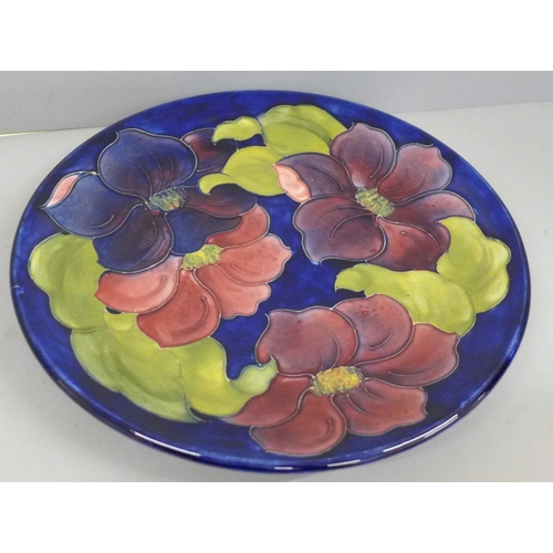 707 - An early 20th Century Moorcroft Clematis pattern charger, 25.5cm