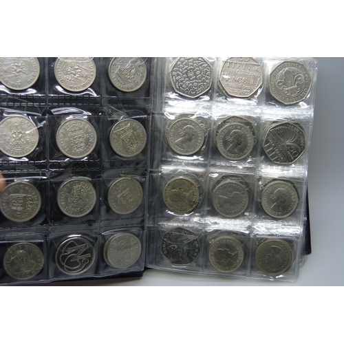 728 - A collection of coins in presentation folder including approximately 90 50p pieces, 20p and 5p