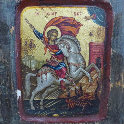 738 - A carved and hand painted Greek icon, St George slaying the dragon, 14.5cm wide