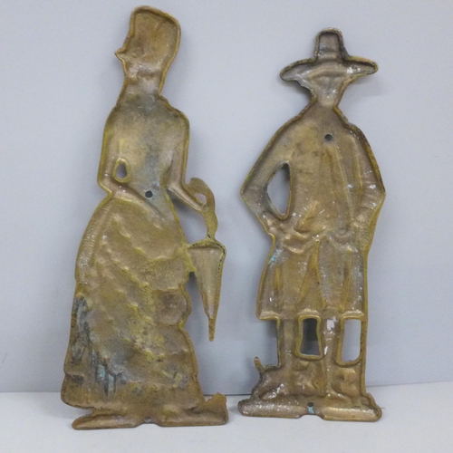 741 - A pair of brass plates depicting a lady and a gentleman, 22cm