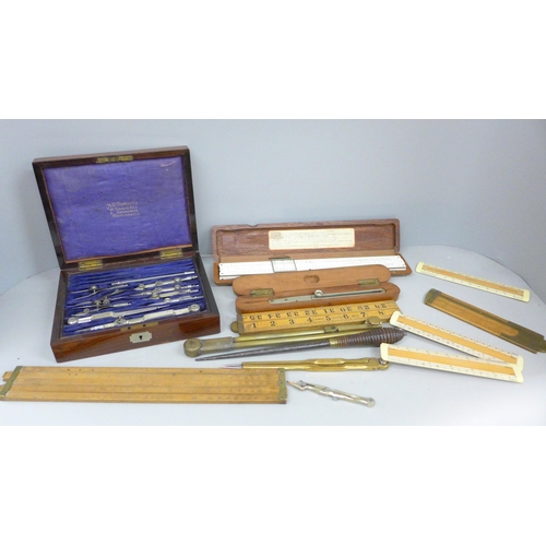 788 - A collection of drawing instruments and rulers including a boxed set