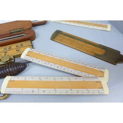 788 - A collection of drawing instruments and rulers including a boxed set