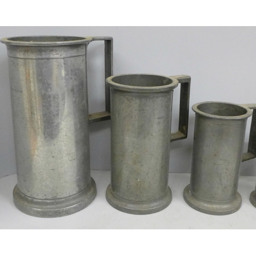 797 - A set of eight pewter tankard measures, largest ‘double litre’ and 23.5cm