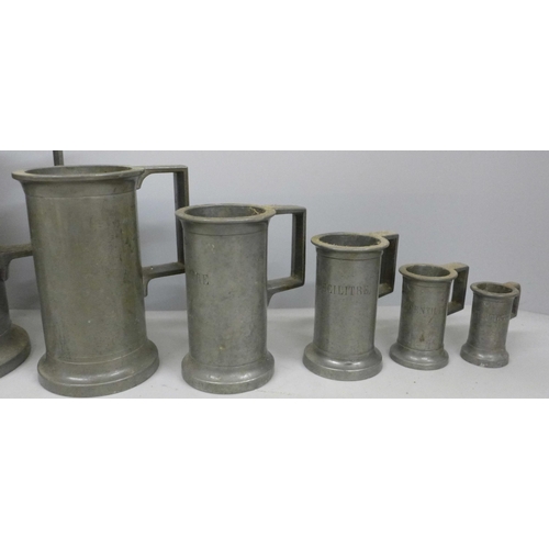 797 - A set of eight pewter tankard measures, largest ‘double litre’ and 23.5cm