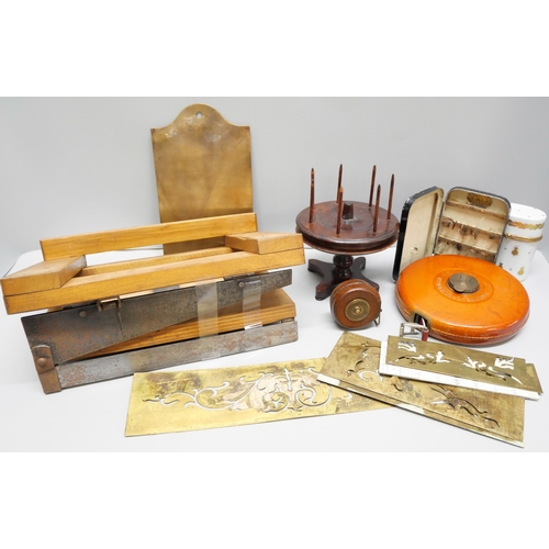 821 - A collection of printing plates, two leather measuring tapes including one dated 1915, a wooden pape... 