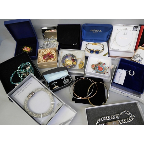 856 - A collection of boxed and packaged costume jewellery