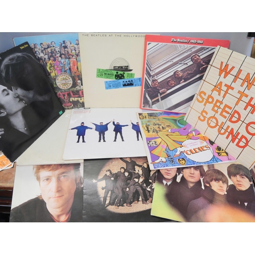 864 - Twelve The Beatles and solo Lp records including numbered White album