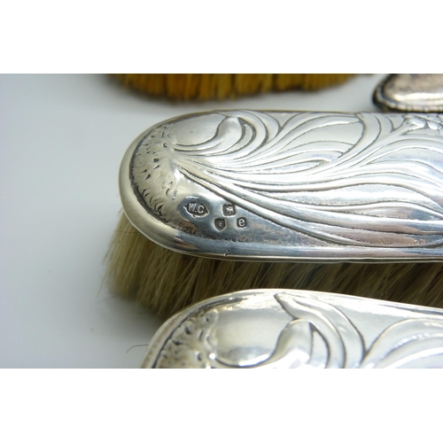 953 - Three silver backed brushes