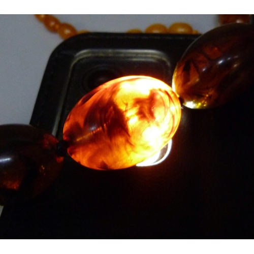 957 - A collection of amber and amber style jewellery including a silver mounted ring