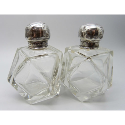 958 - A collection of silver mounted scent bottles - three lacking stoppers, one lid unremovable, one lid ... 