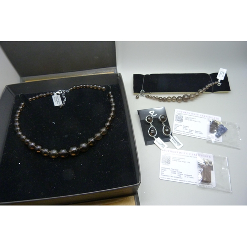 974 - A collection of silver and smokey quartz jewellery including a necklace, bracelet and earrings from ... 