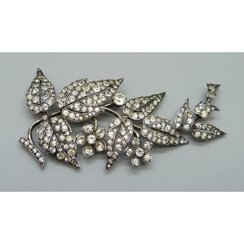 978 - An early 20th Century white metal articulated paste set brooch, 8.5cm, 21g, one stone missing