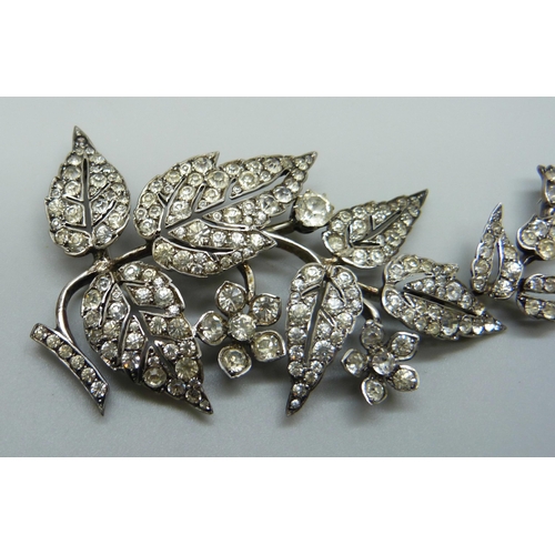 978 - An early 20th Century white metal articulated paste set brooch, 8.5cm, 21g, one stone missing