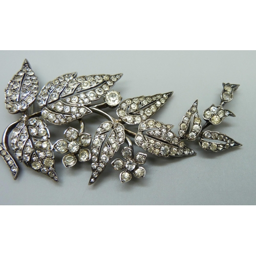 978 - An early 20th Century white metal articulated paste set brooch, 8.5cm, 21g, one stone missing