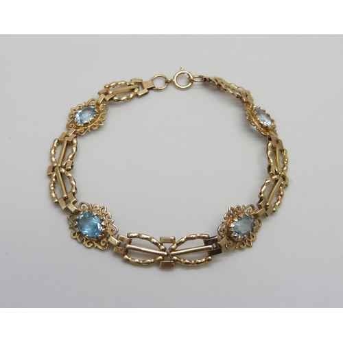 984 - A 9ct gold bracelet set with four topaz stones, one replacement, 5.8g