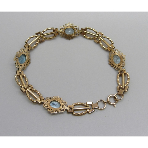 984 - A 9ct gold bracelet set with four topaz stones, one replacement, 5.8g