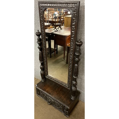 139 - A Jacobean Revival carved oak cheval mirror