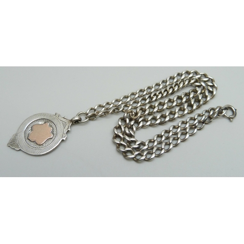 992 - A silver graduated curb link watch chain and a silver gold fronted fob, clasp requires repair, 42cm,... 