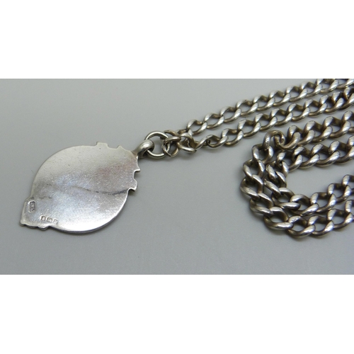 992 - A silver graduated curb link watch chain and a silver gold fronted fob, clasp requires repair, 42cm,... 