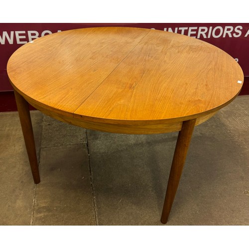 55A - A G-Plan Fresco teak extending circular dining table