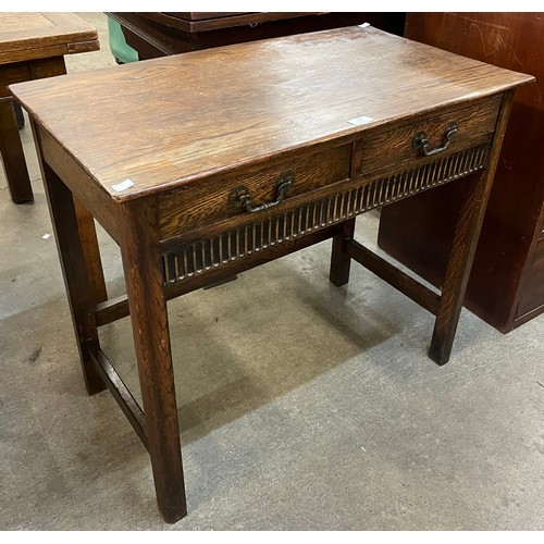 206 - An early 20th Century carved oak two drawer side table