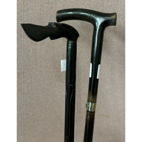 270 - Two ebonised walking canes, one with silver collar