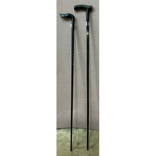 270 - Two ebonised walking canes, one with silver collar