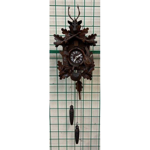 288 - A Black Forest style carved oak cuckoo clock