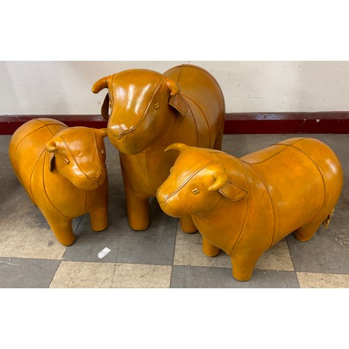 293 - Three Liberty & Co. style butterscotch leather footstools, a bull and two calves