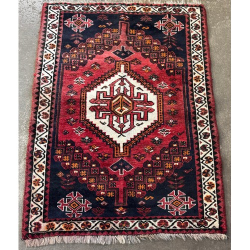 213D - An Eastern red ground rug (148cm x 108cm)