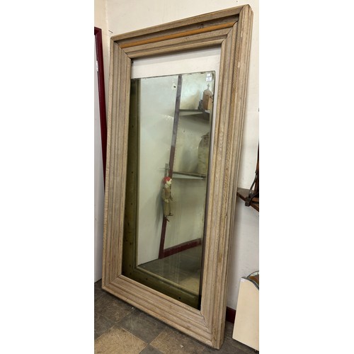 305 - A very large oak framed mirror, glass loose from frame