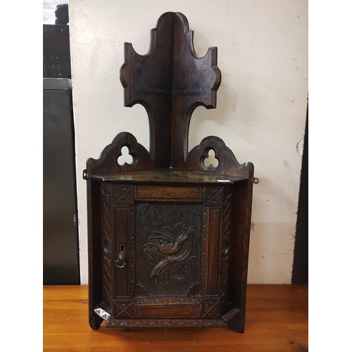 237A - A Jacobean Revival small carved oak corner cupboard