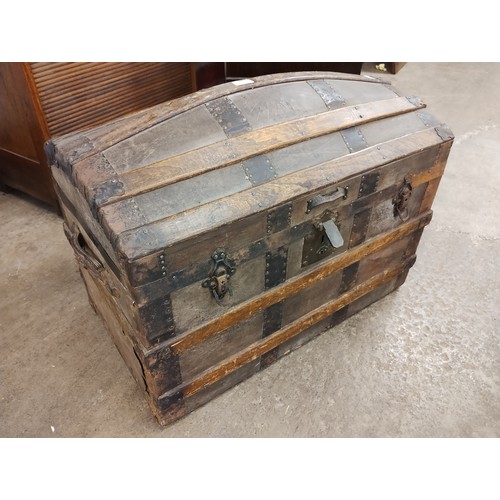 241 - An oak and leather dome topped chest