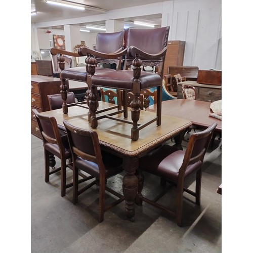 208 - An early 20th Century carved oak extending dining table and six oak and leather dining chairs