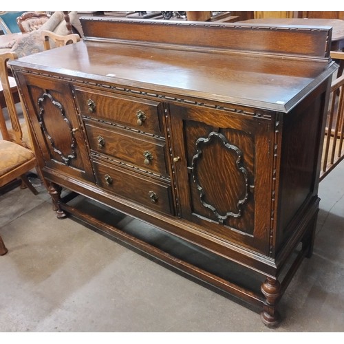 209 - An early 20th Century carved oak sideboard