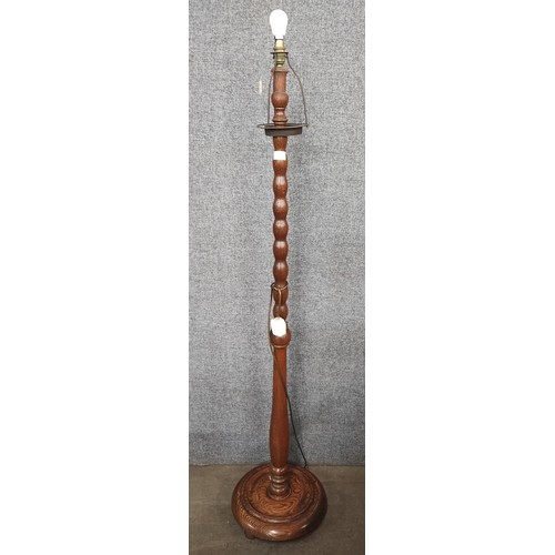 213 - An early 20th Century oak standard lamp