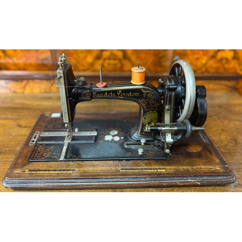 252D - A Faudels cast iron mother of pearl cased sewing machine