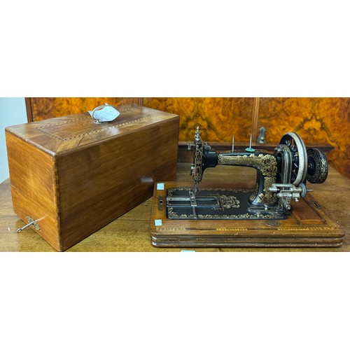 252E - A cased cast iron Frister & Rossman sewing machine