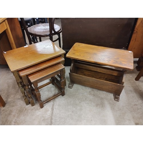 221 - An early 20th Century oak nest of tables and magazine rack