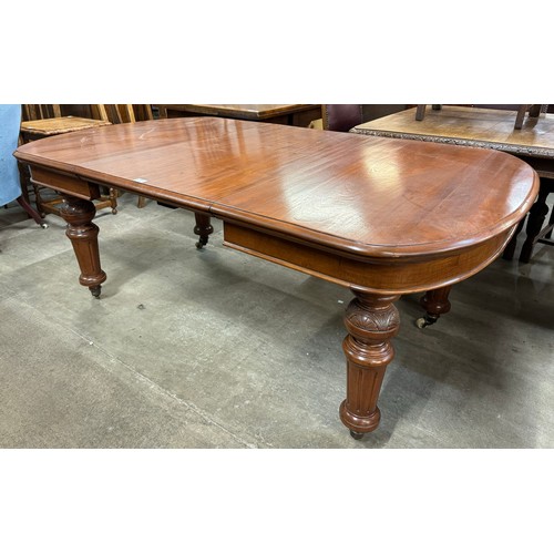 214 - A Victorian carved walnut extending dining table