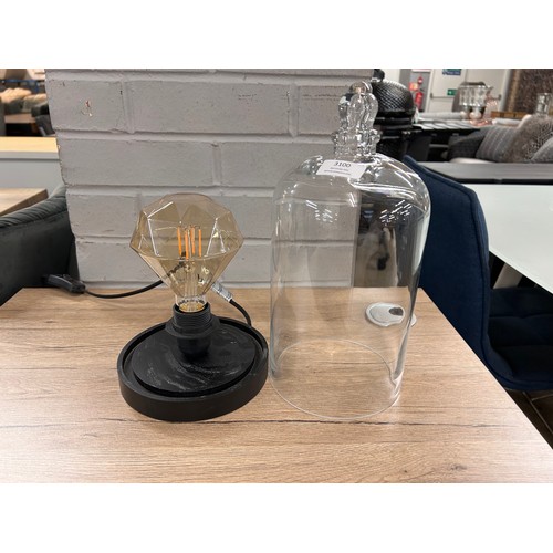 3100 - A table lamp enclosed in a glass case