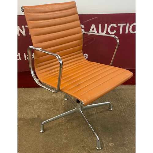 10 - An Eames style chrome and tan leather revolving desk chair