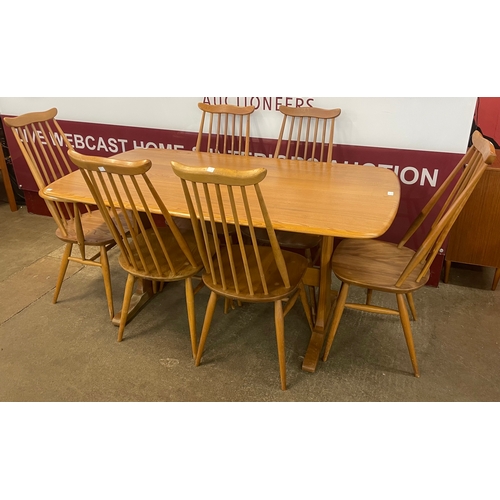 15 - An Ercol Blonde elm Windsor dining table and six Goldsmith chairs