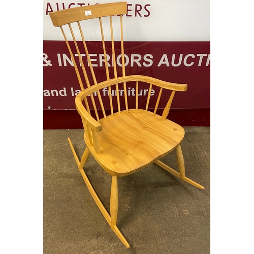 25 - An elm and beech comb back rocking chair